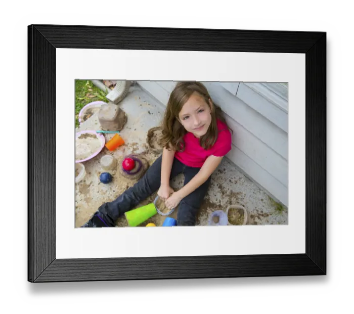 Framed Print : Girl playing with mud in a messy soil smiling portrait looing from high point Framed Print : Girl playing with mud in a messy soil smiling portrait looing from high point