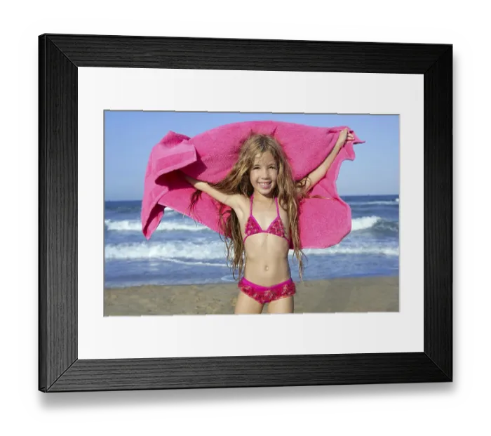 Framed Print : Beach little girl playing pink towel and wind in blue sea