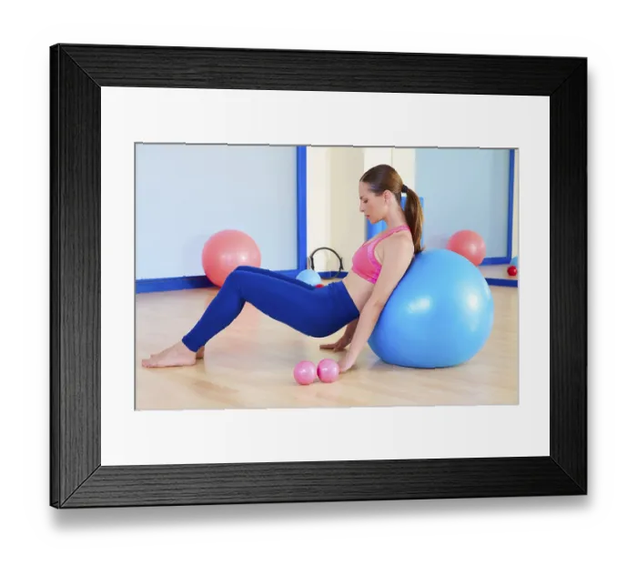 Framed Print : Pilates woman fitball swiss ball exercise workout at gym indoor
