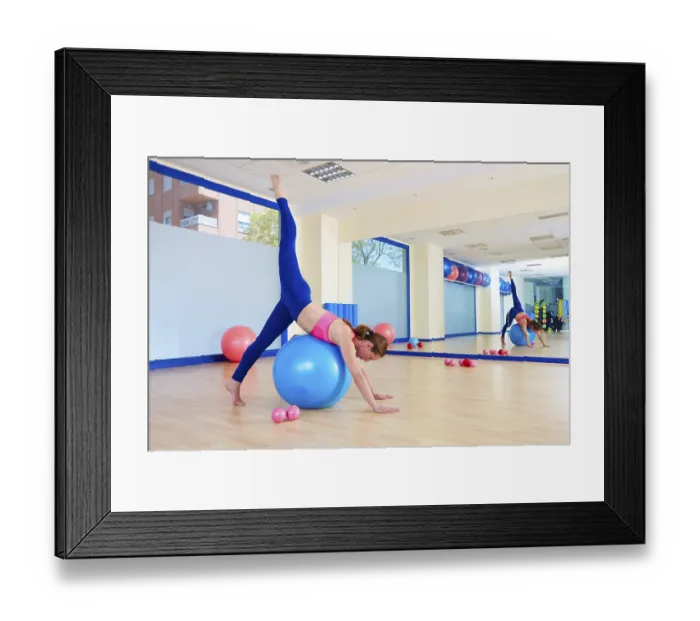 Framed Print : Pilates woman fitball arabesque exercise workout at gym indoor