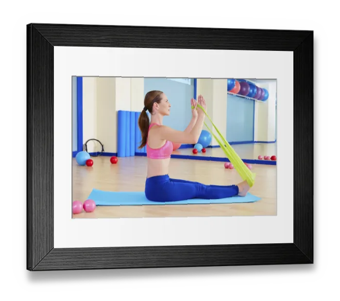 Framed Print : Pilates woman rowing rubber band exercise workout at gym indoor