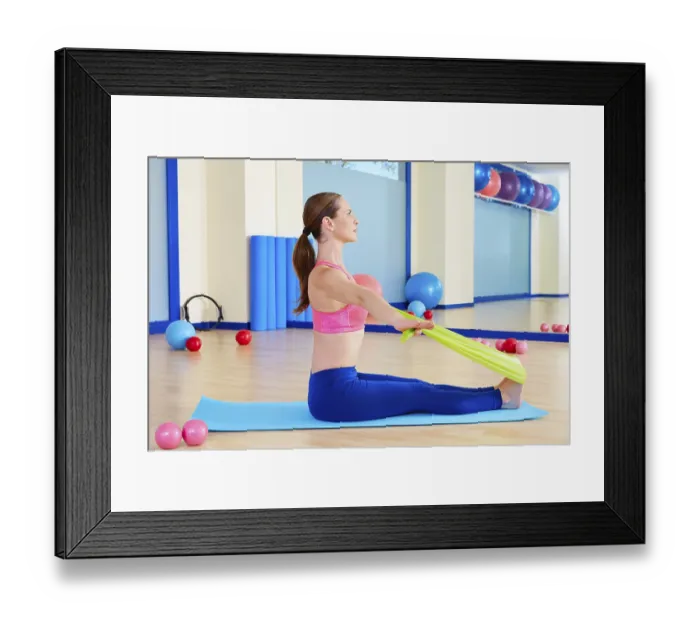 Framed Print : Pilates woman rowing rubber band exercise workout at gym indoor Framed Print : Pilates woman rowing rubber band exercise workout at gym indoor