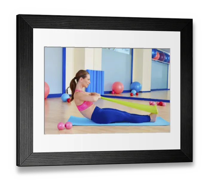 Framed Print : Pilates woman rowing rubber band exercise workout at gym indoor Framed Print : Pilates woman rowing rubber band exercise workout at gym indoor