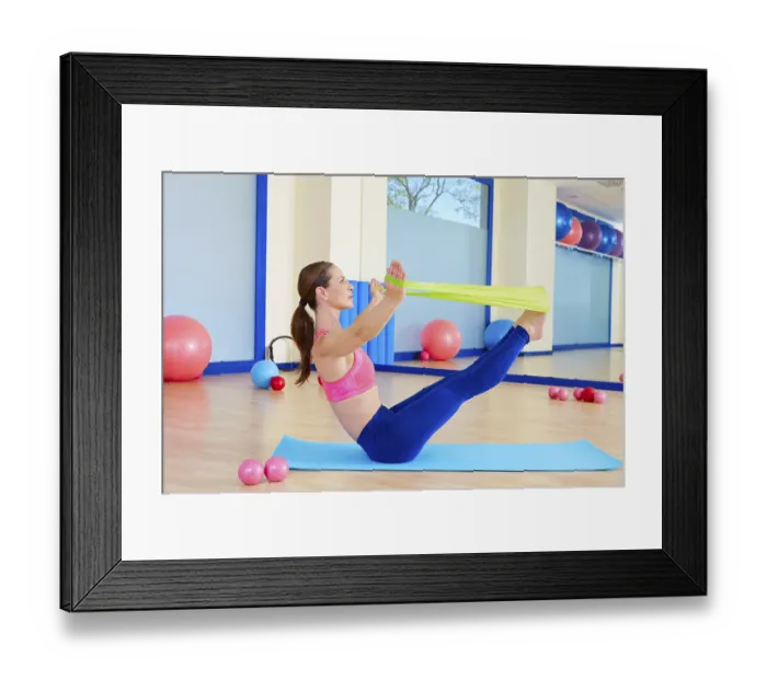 Framed Print : Pilates woman teaser rubber band exercise workout at gym indoor