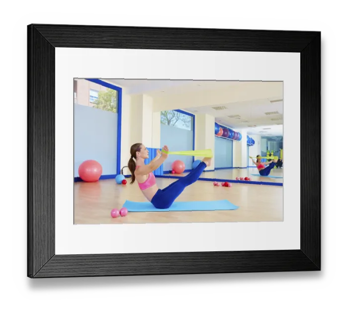 Framed Print : Pilates woman teaser rubber band exercise workout at gym indoor