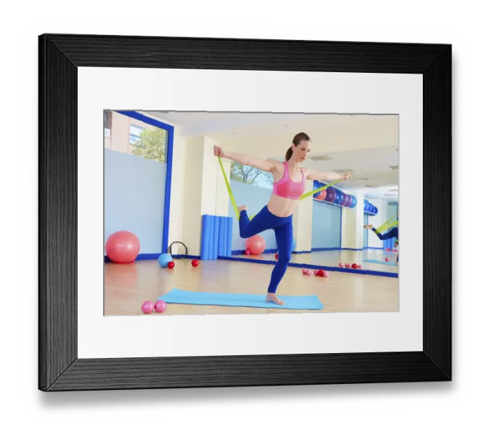 Framed Print : Pilates woman standing rubber band exercise workout at gym indoor Framed Print : Pilates woman standing rubber band exercise workout at gym indoor