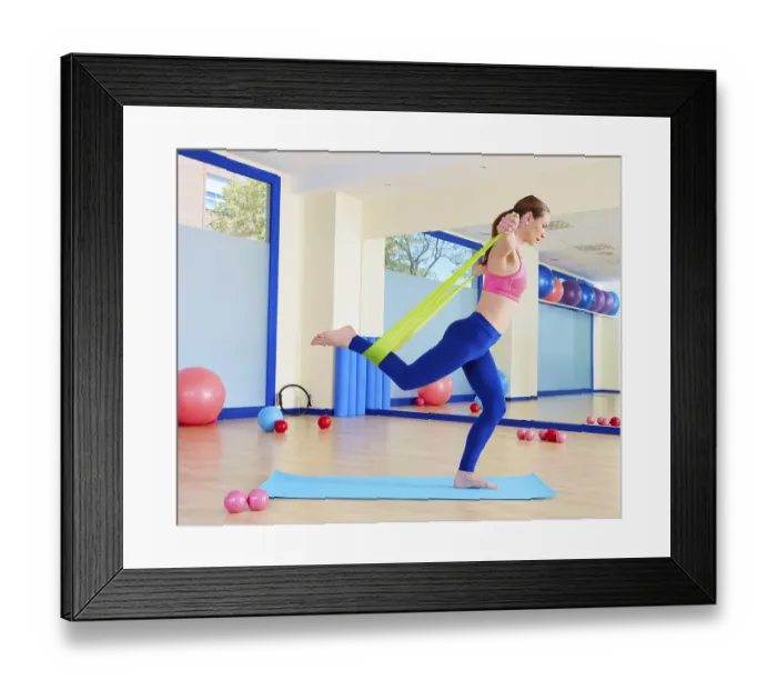 Framed Print : Pilates woman standing rubber band exercise workout at gym indoor