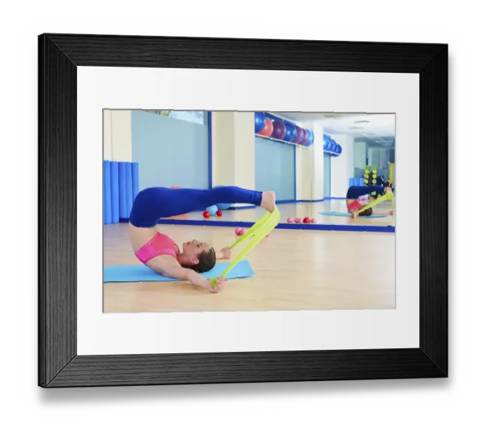 Framed Print : Pilates woman roll over rubber band exercise workout at gym indoor