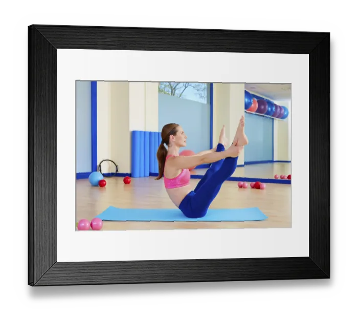 Framed Print : Pilates woman open leg rocker exercise workout at gym indoor