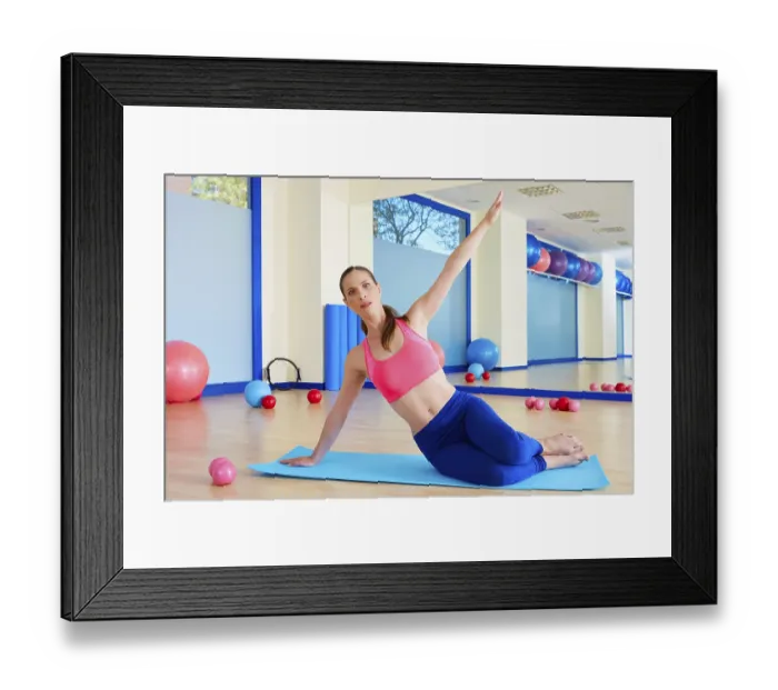 Framed Print : Pilates woman stretching exercise workout at gym indoor