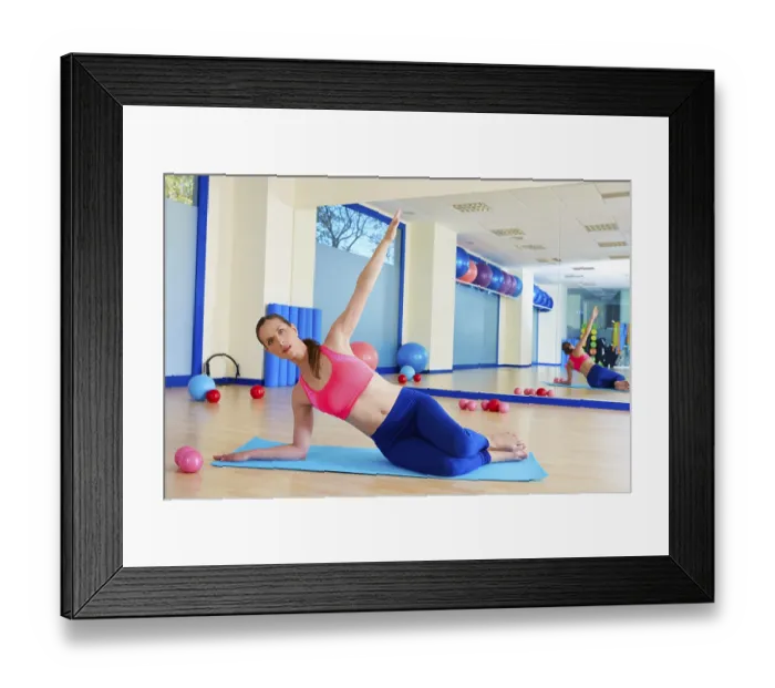 Framed Print : Pilates woman stretching exercise workout at gym indoor