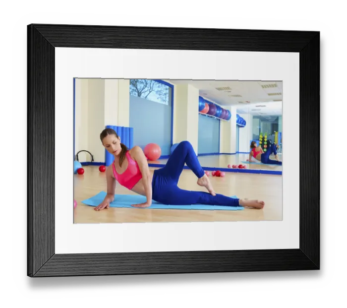 Framed Print : Pilates woman stretching exercise workout at gym indoor