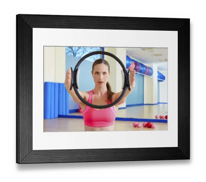 Framed Print : Pilates woman magic ring hands exercise workout at gym indoor