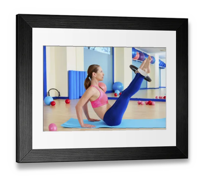 Framed Print : Pilates woman hip twist magic ring exercise workout at gym indoor