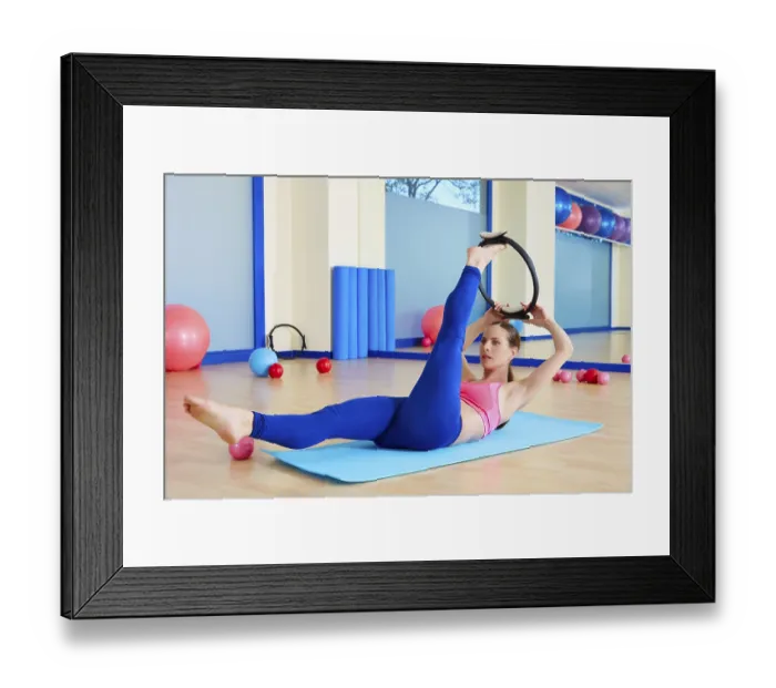 Framed Print : Pilates woman scissor magic ring exercise workout at gym indoor