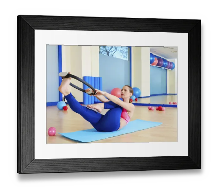 Framed Print : Pilates woman single leg stretch magic ring exercise workout at gym indoor