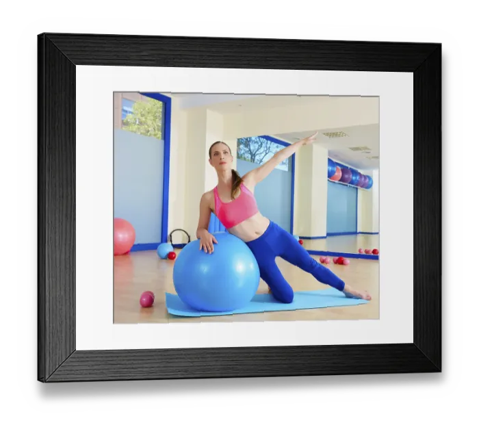 Framed Print : Pilates woman side bend fitball exercise workout at gym indoor swiss ball Framed Print : Pilates woman side bend fitball exercise workout at gym indoor swiss ball