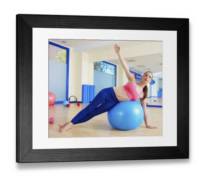 Framed Print : Pilates woman side bend fitball exercise workout at gym indoor swiss ball