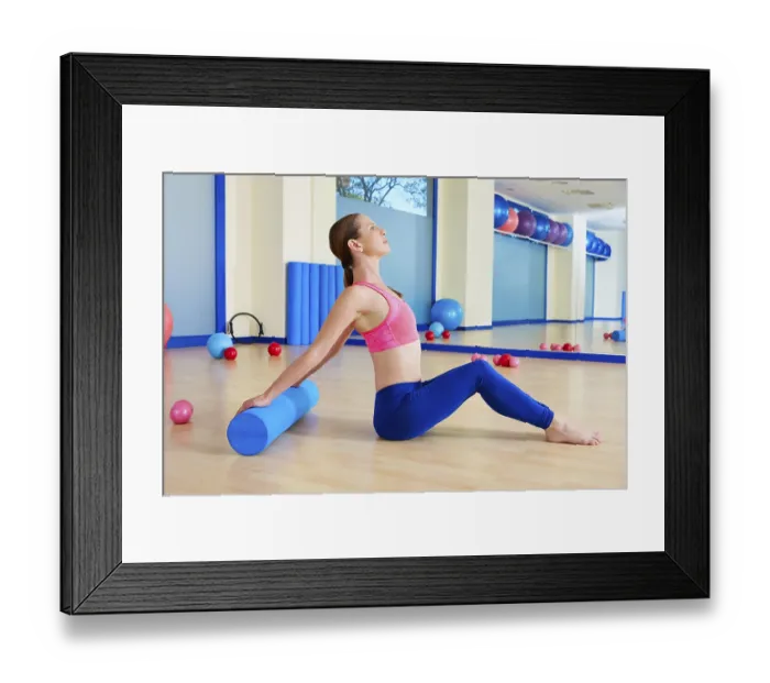 Framed Print : Pilates woman roller exercise workout at gym indoor