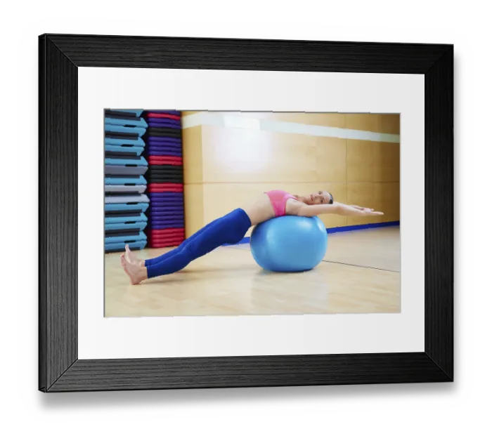 Framed Print : Pilates woman abdo fitball exercise workout at gym indoor swiss ball