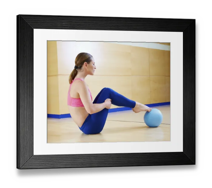 Framed Print : Pilates woman stability ball exercise workout at gym indoor