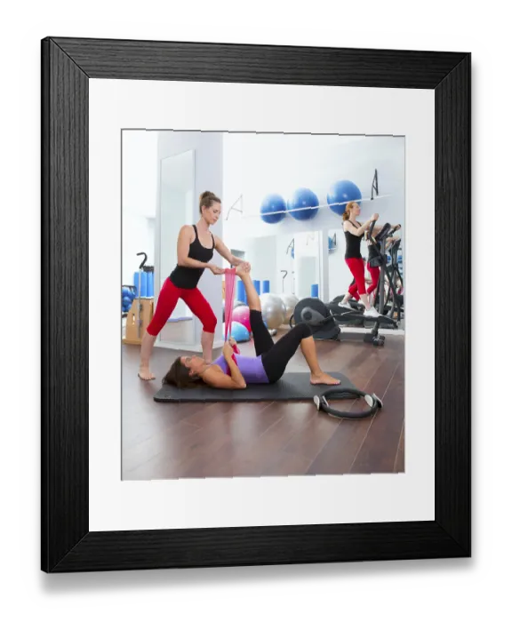 Framed Print : Aerobics pilates gym women personal trainer with ribber band