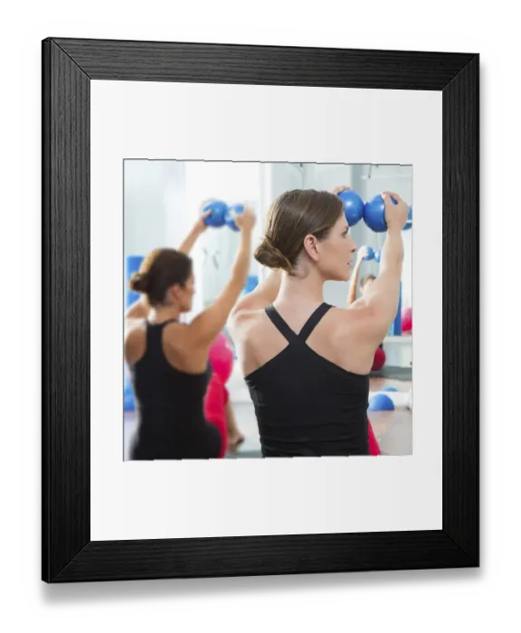 Framed Print : Pilates toning ball in women fitness class rear mirror view