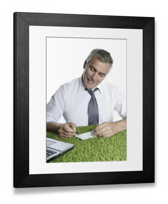 Framed Print : Senior businessman signing bank check over green grass desk sport ecology