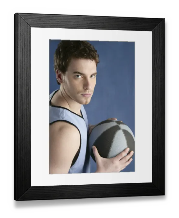 Framed Print : Basket player young man over blue grunge background