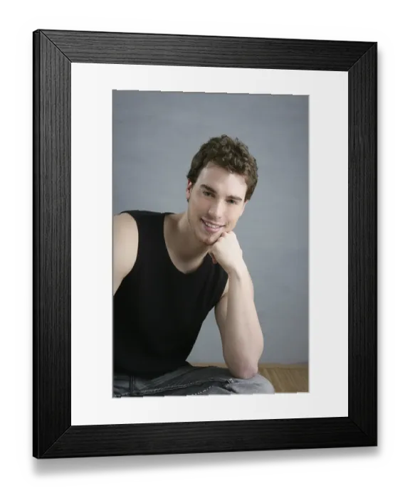 Framed Print : Casual young man portrait sit over gray grunge background