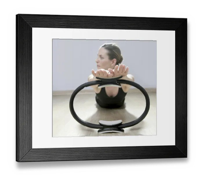 Framed Print : Beautiful instructor woman with magic pilates ring in sport gym