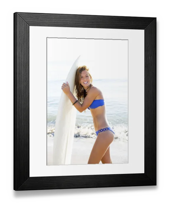 Framed Print : Beautiful surfer teen girl with surfboard on beach shore high key
