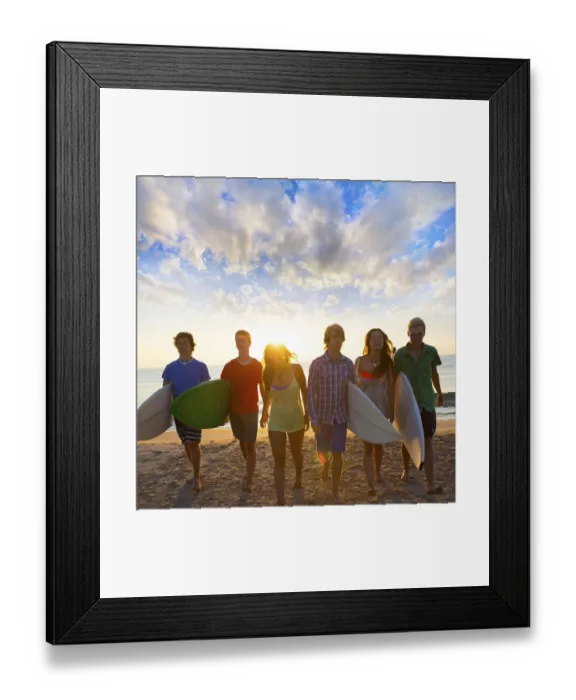 Framed Print : Surfers teen boys and girls group walking on beach at sunshine sunset backlight