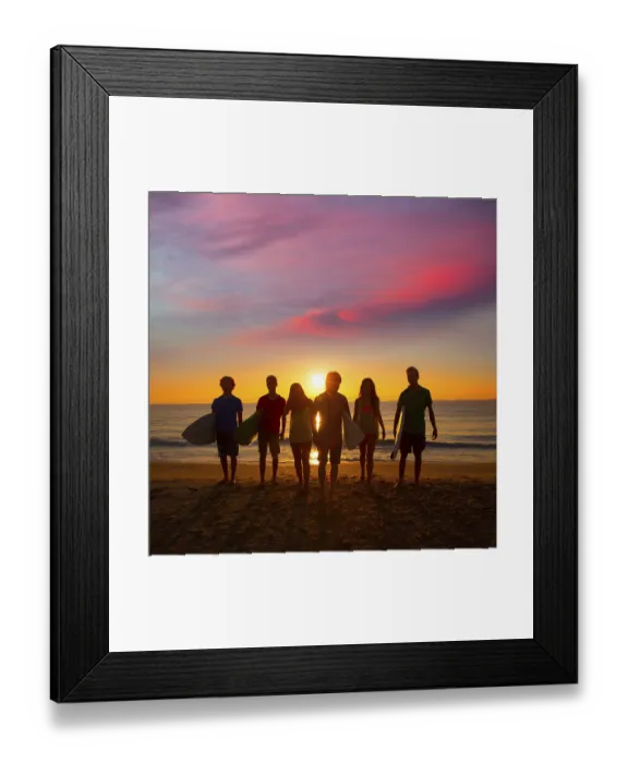 Framed Print : Surfers teen boys and girls group walking on beach at sunshine sunset backlight