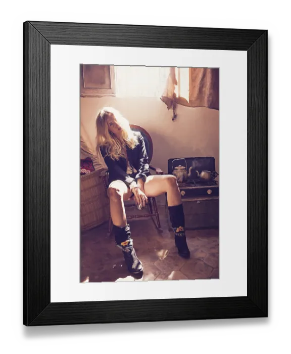 Framed Print : Blond fashion girl drinking tea in a grunge indoor relaxed on vintage chair