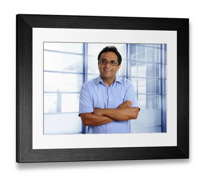 Framed Print : Indian latin businessman with glasses and blue shirt in modern office