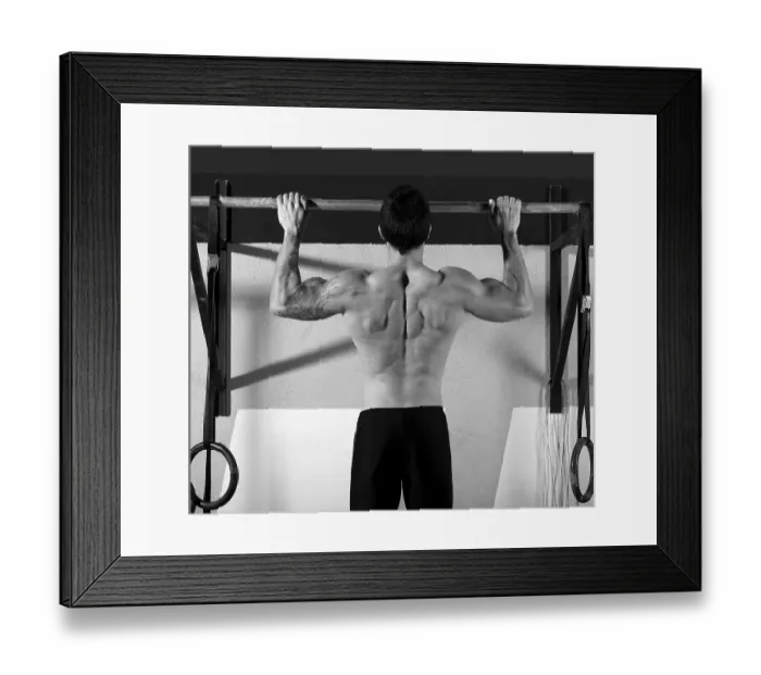 Framed Print : Crossfit toes to bar man pull-ups 2 bars workout exercise at gym
