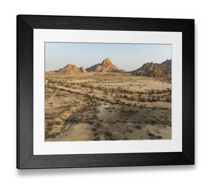 Framed Print : The isolated Spitzkoppe mountain (1728 m) majestically rises above the surrounding desert plains