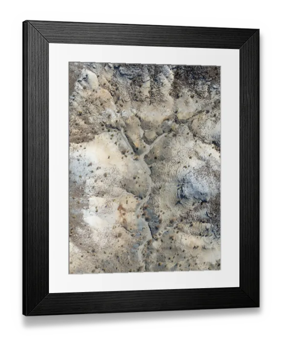 Framed Print : Broken, rocky ground with sparse vegetation