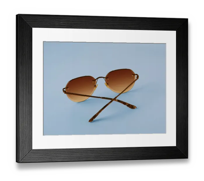 Framed Print : Glasses with orange lenses on blue background