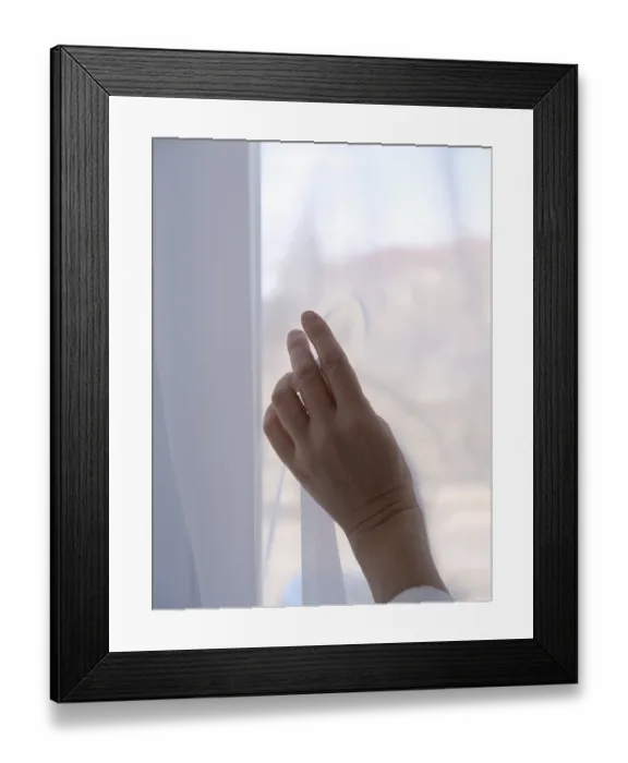 Framed Print : Female hand against the background of a window curtained with transparent fabric
