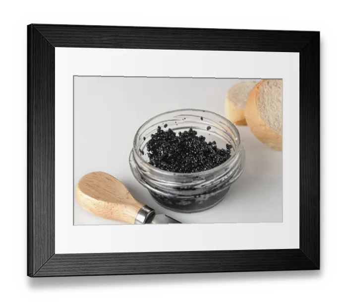 Framed Print : Halibut caviar in a glass jar on a white background