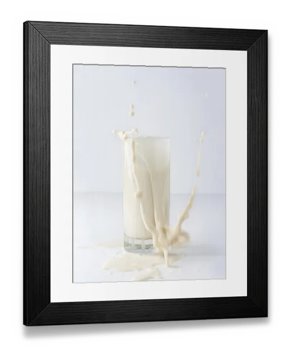Framed Print : Quaint splash of vegetable milk in a tall glass on a white background