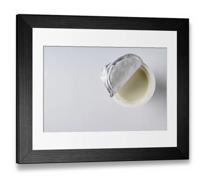 Framed Print : Open a package with yogurt on a white background