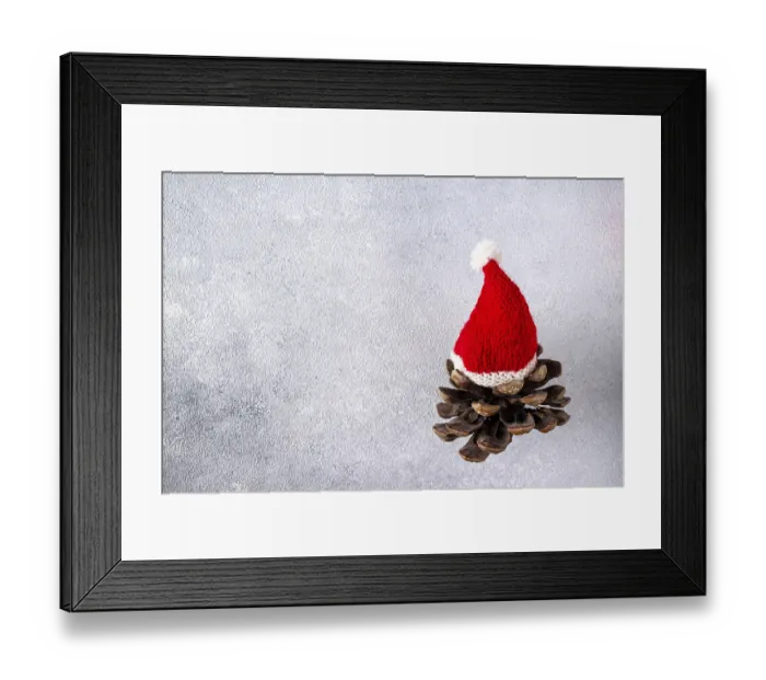 Framed Print : A cedar cone in a Santa hat flies on a gray background Framed Print : A cedar cone in a Santa hat flies on a gray background