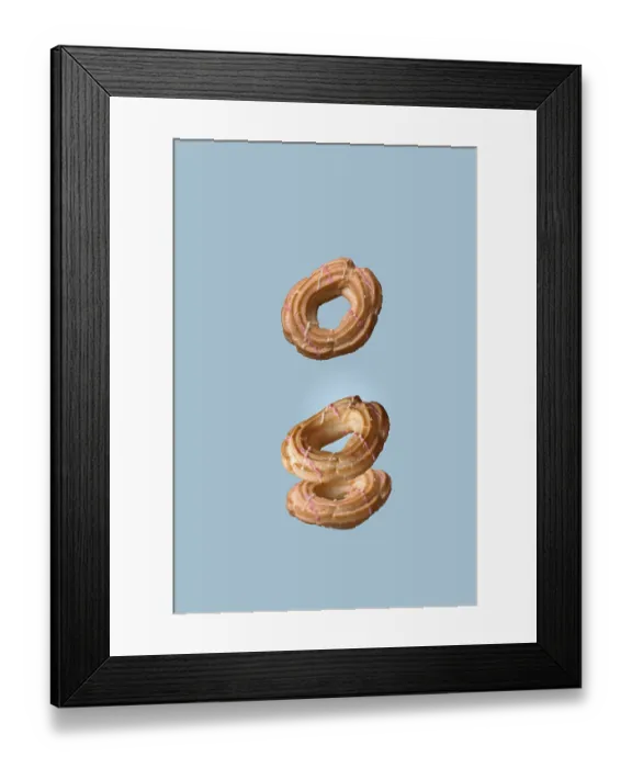 Framed Print : Choux pastry donuts flying on a blue background