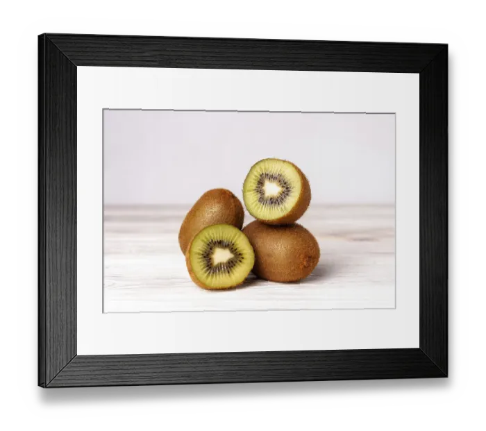 Framed Print : Kiwi slices on a white wooden table