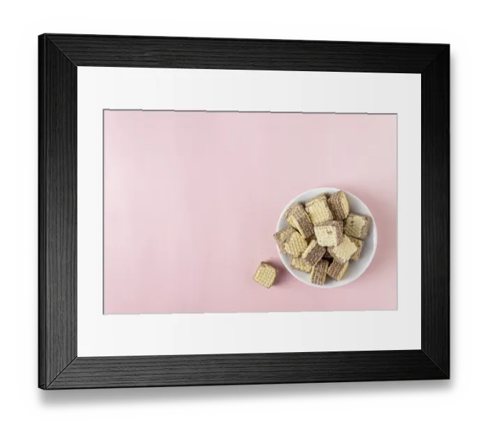 Framed Print : Chocolate mini waffles on a pink background