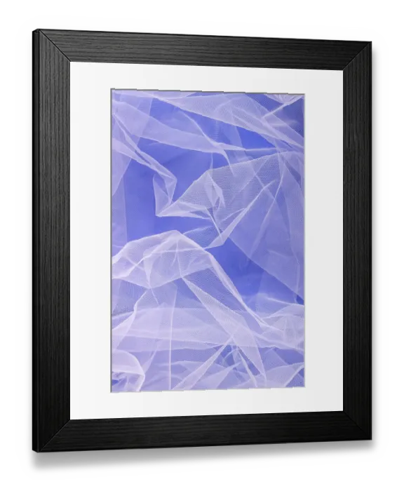 Framed Print : Sheer tulle fabric arranged in soft folds on a blue background