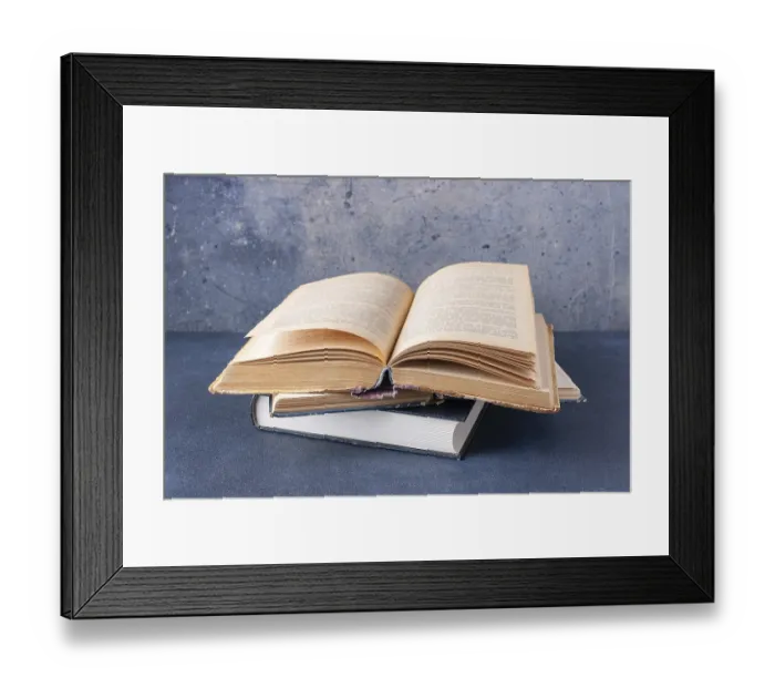 Framed Print : Open vintage book on blue background with copy space